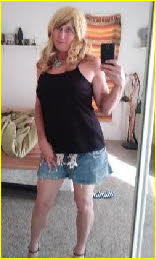 Sexy crossdresser in short denim skirt