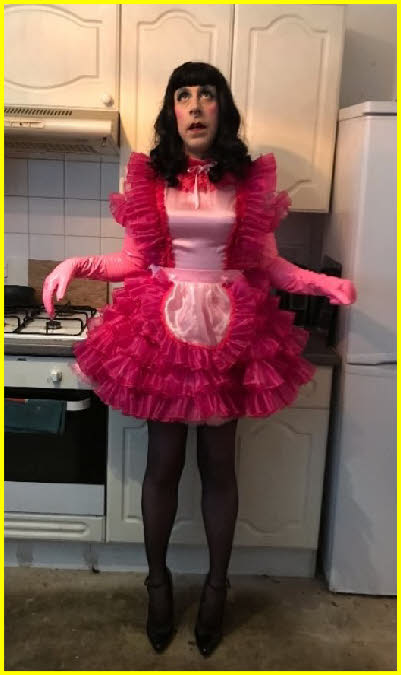 Effeminate sissy maid  in frilly pink uniform
