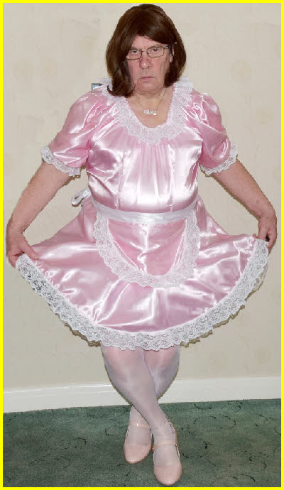 Cross-dressing sissy curtsies in pink French maid uniform Cross-dressing sissy curtsies in pink French maid uniform