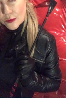Mistress CP brandishes her riding crop for spanking slaves