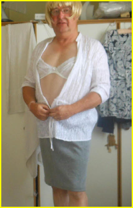 Sissy Mick opens his blouse to expose white bra Sissy Mick opens his blouse to expose white bra