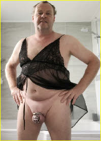 Sissy Jenny flaunts his caged cock while dressed in a black baby doll nightie