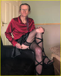 Cross-dressing sissy Darren Kelly flashes his stocking tops Cross-dressing sissy Darren Kelly flashes his stocking tops