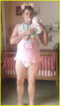 Dummy-sucking adult baby in nursery