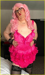 Degraded male humiliates himself in long pink wig and frilly knickers