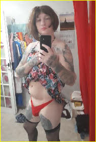 Sissy Riby hitches up his dress to show off his girlie red panties Sissy Riby hitches up his dress to show off his girlie red panties