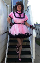Feminine man exposed in frilly pink maid dress