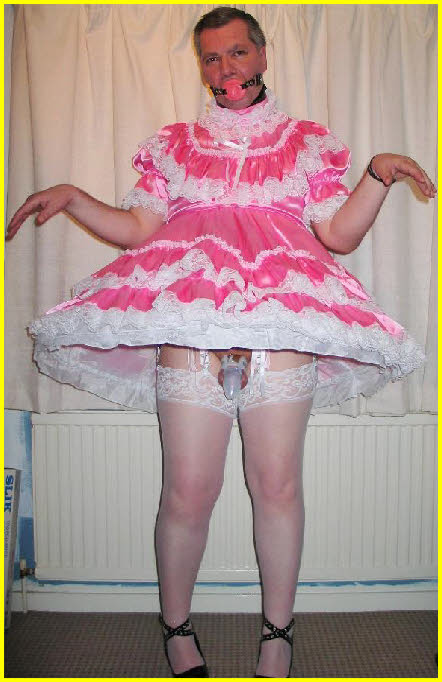 Sissy cross-dresser shows off caged cock